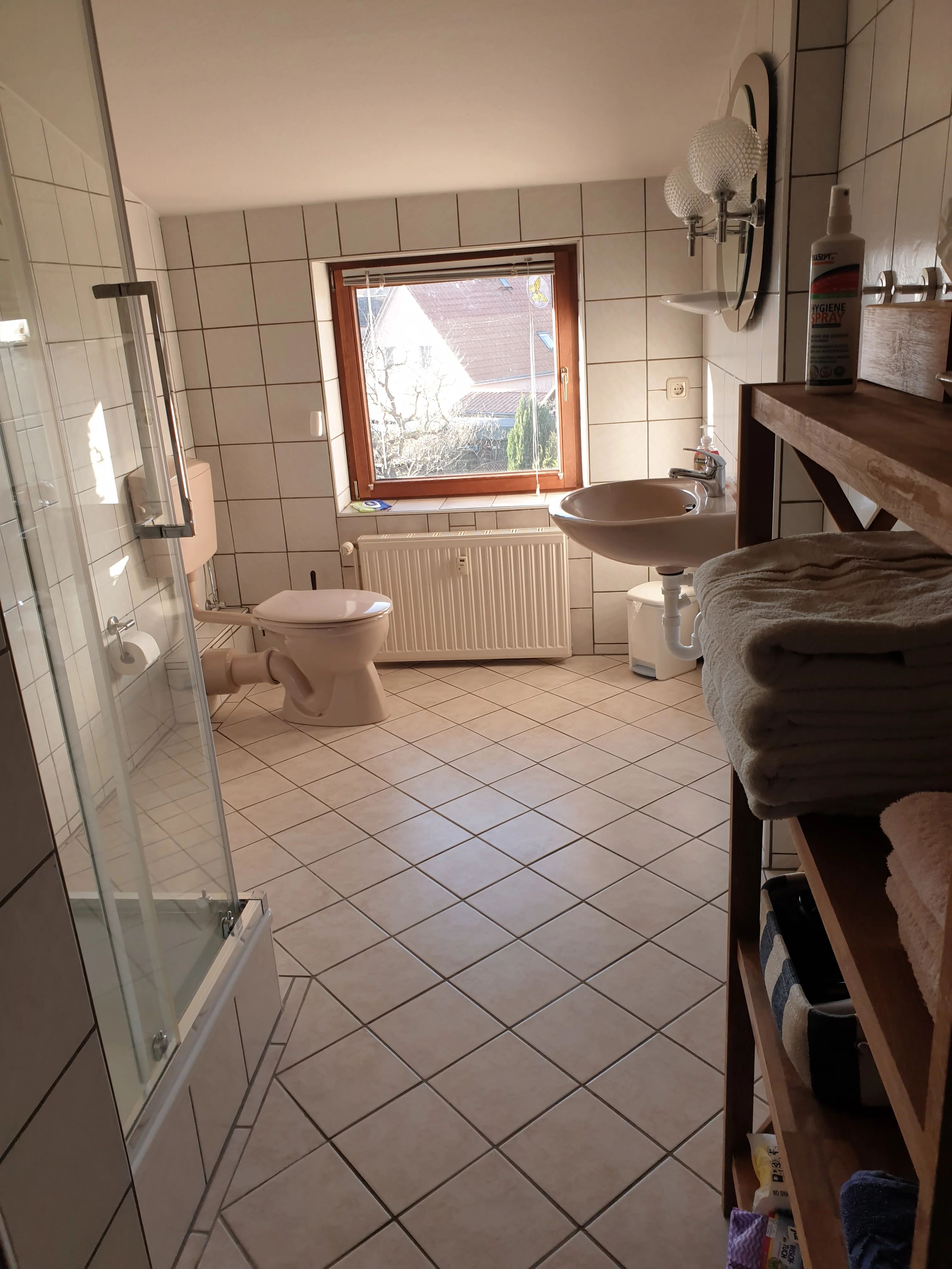 Bad der Obergeschosswohnung mit Dusche und Badartikeln